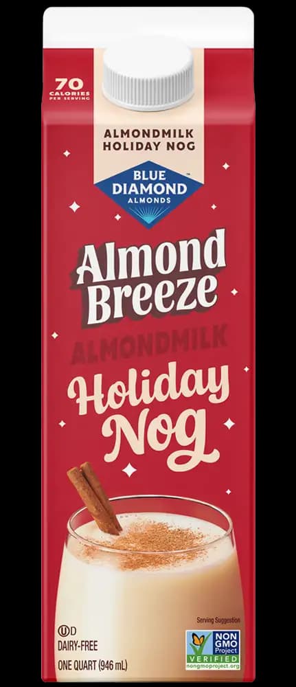 A carton of Almond Breeze Almondmilk Holiday Nog, featuring a glass of nog with cinnamon sticks on the front. The carton notes it is dairy-free, non-GMO, and contains 70 calories per serving.