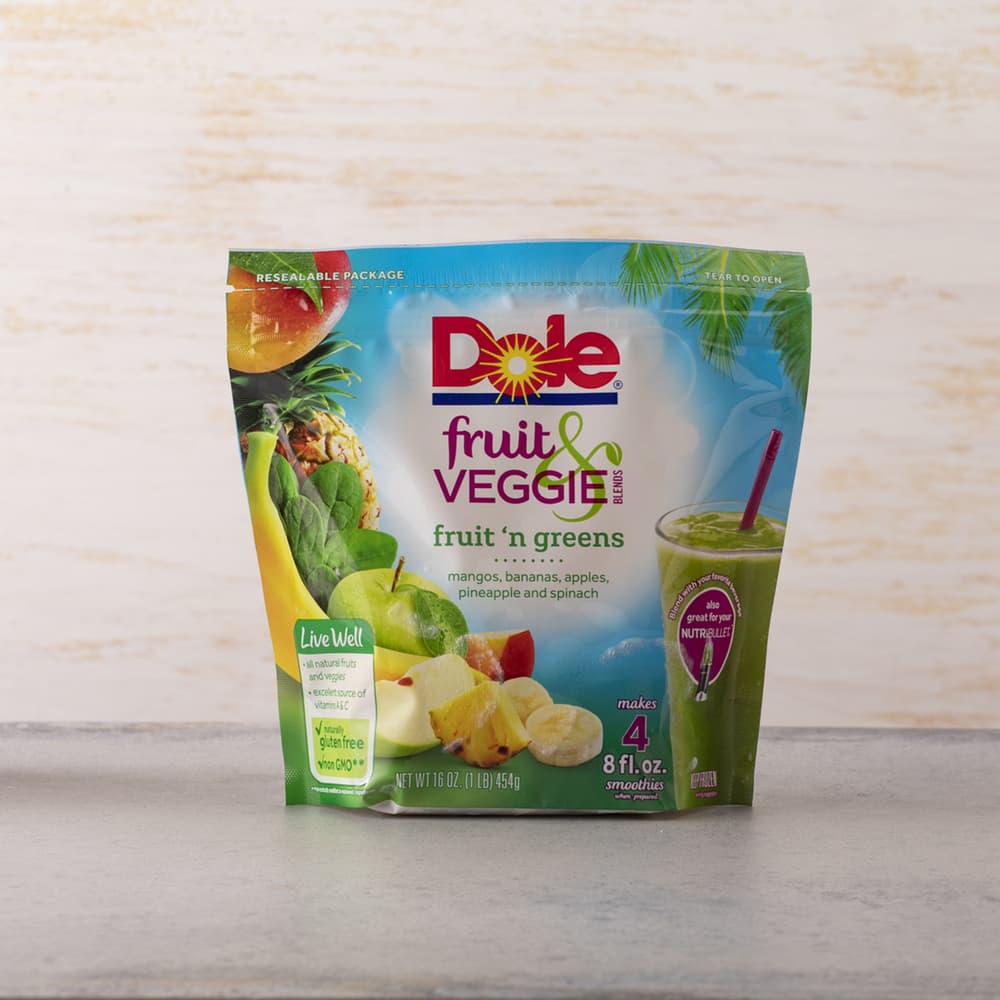 A resealable bag of Dole Fruit & Veggie Blends Fruit n Greens, featuring images of fruits and greens, labeled as containing mangos, bananas, apples, pineapple, and spinach.