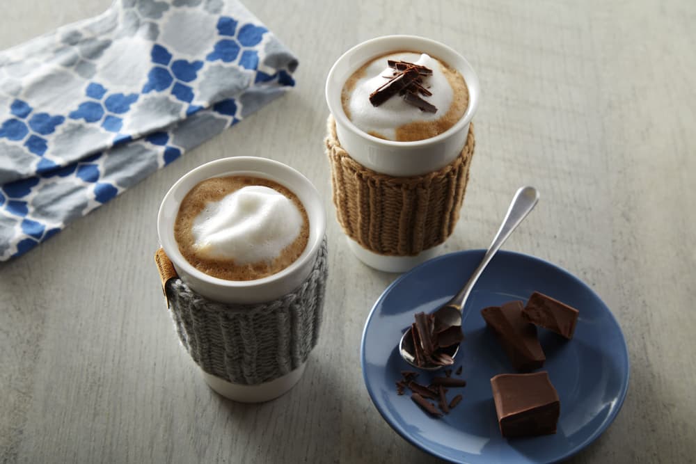 Creamy chocolate mocha mugs topped with frothed Almond Breeze Extra Creamy Almondmilk
