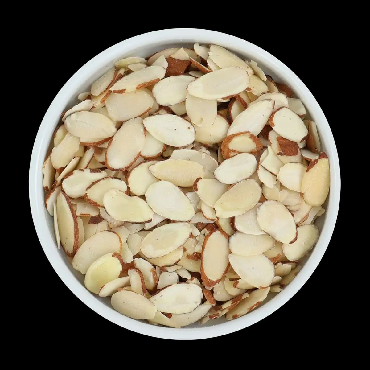 A white bowl filled with thinly sliced almonds, some with brown skin on the edges, shown on a black background.