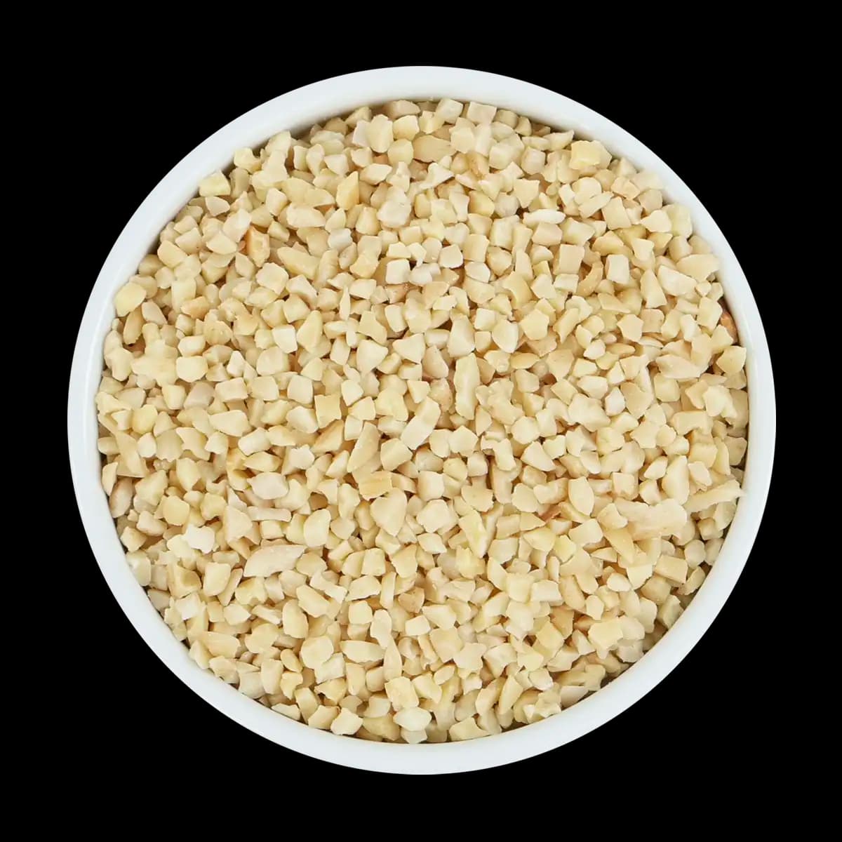 A white bowl filled with chopped nuts, viewed from above, set against a solid black background.