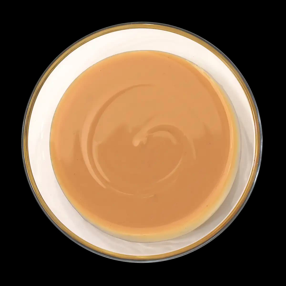 A round, smooth caramel flan sits on a white plate, viewed from above, showing a glossy caramel layer on top.