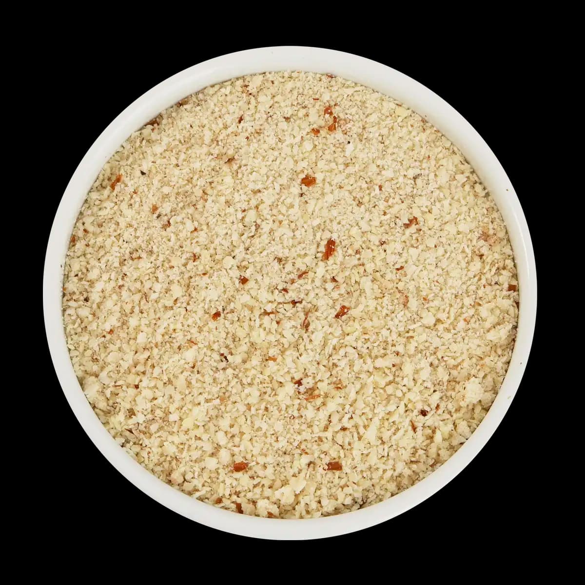 A white bowl filled with finely ground nuts, viewed from above, on a black background.