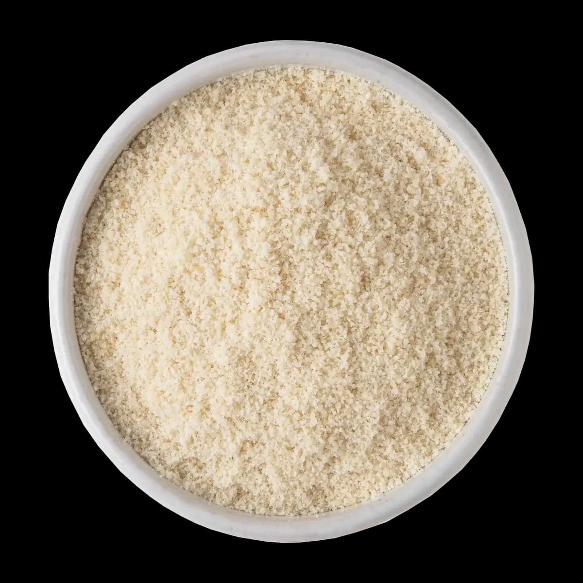 A white bowl filled with finely ground, light beige powder, viewed from above against a black background.