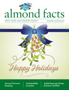 Cover of almond facts magazine featuring a blue bow, mistletoe, and Happy Holidays text, with article highlights on annual growers meeting, sustainability, and business certification.