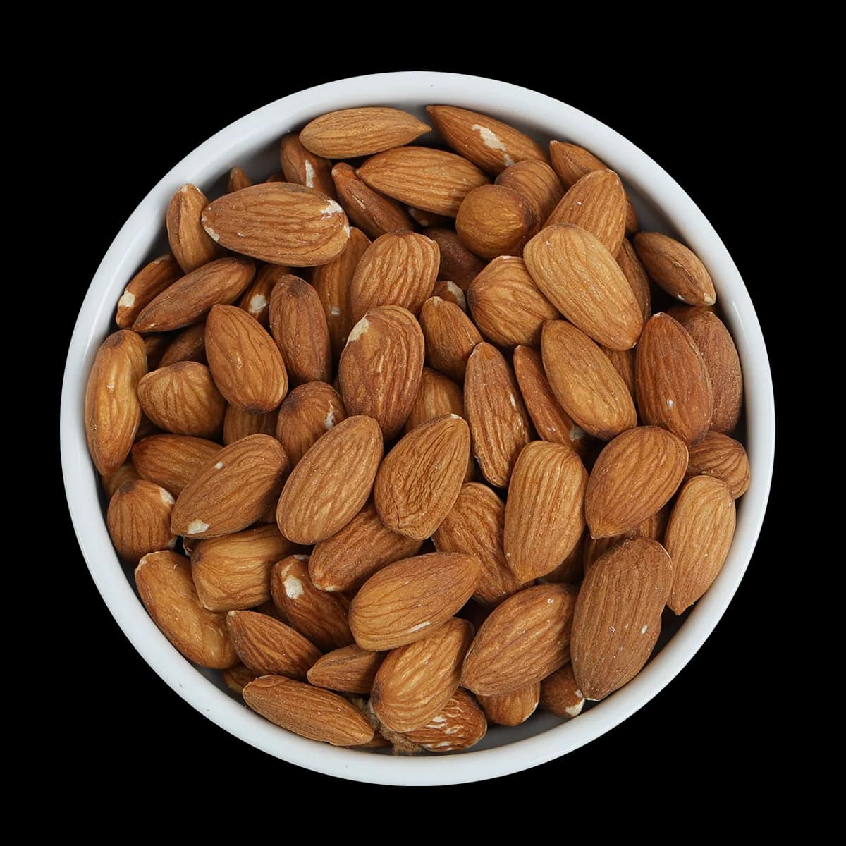 A white bowl filled with unshelled, whole almonds is shown against a solid black background.