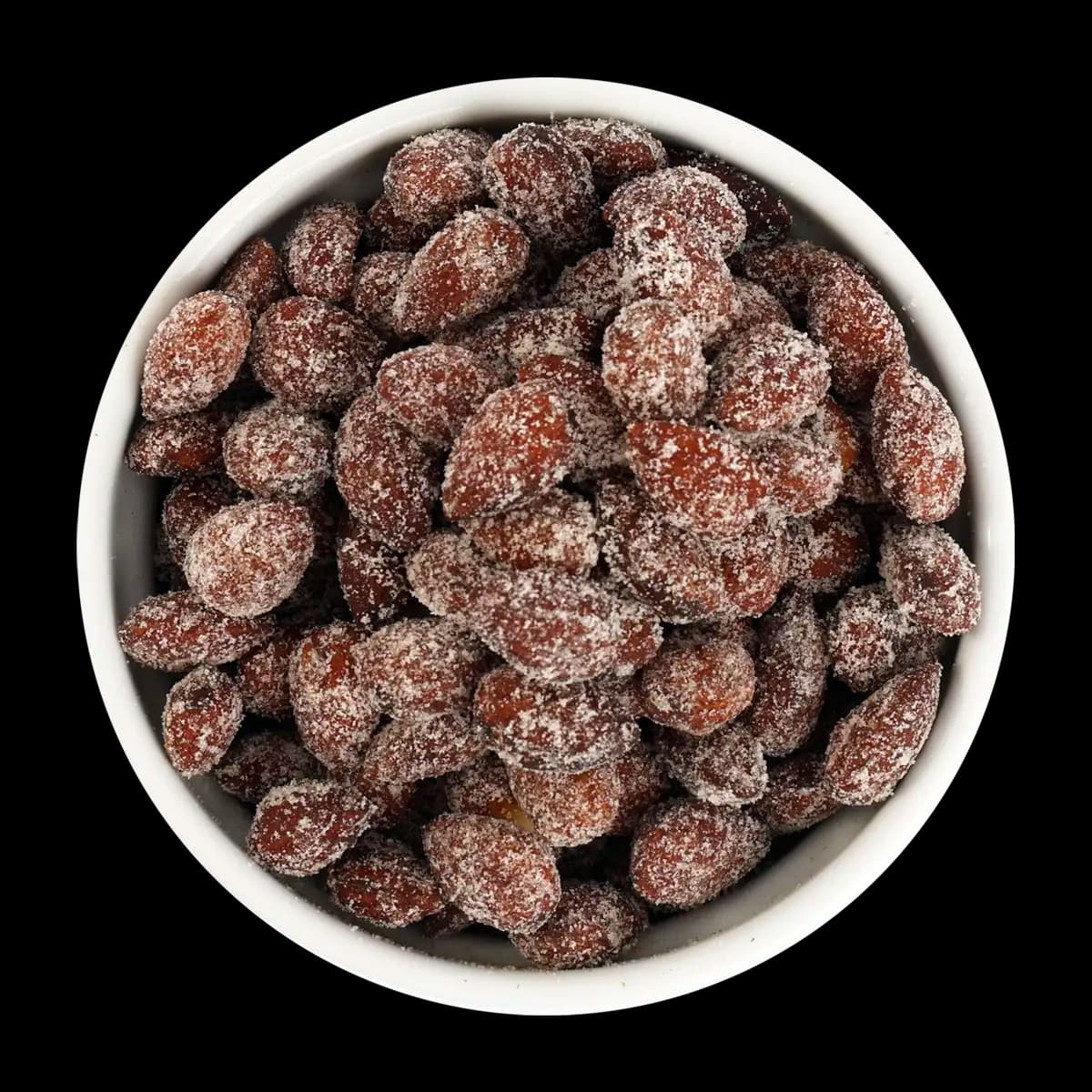 A white bowl filled with roasted almonds covered in a sugar coating, shown against a black background.