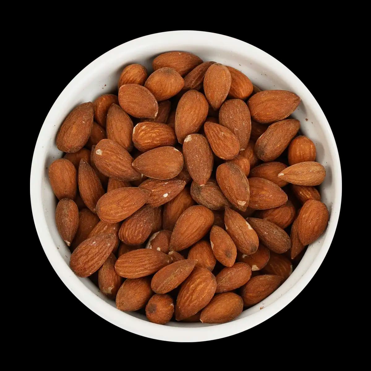 A white bowl filled with whole, unpeeled almonds is shown against a black background.