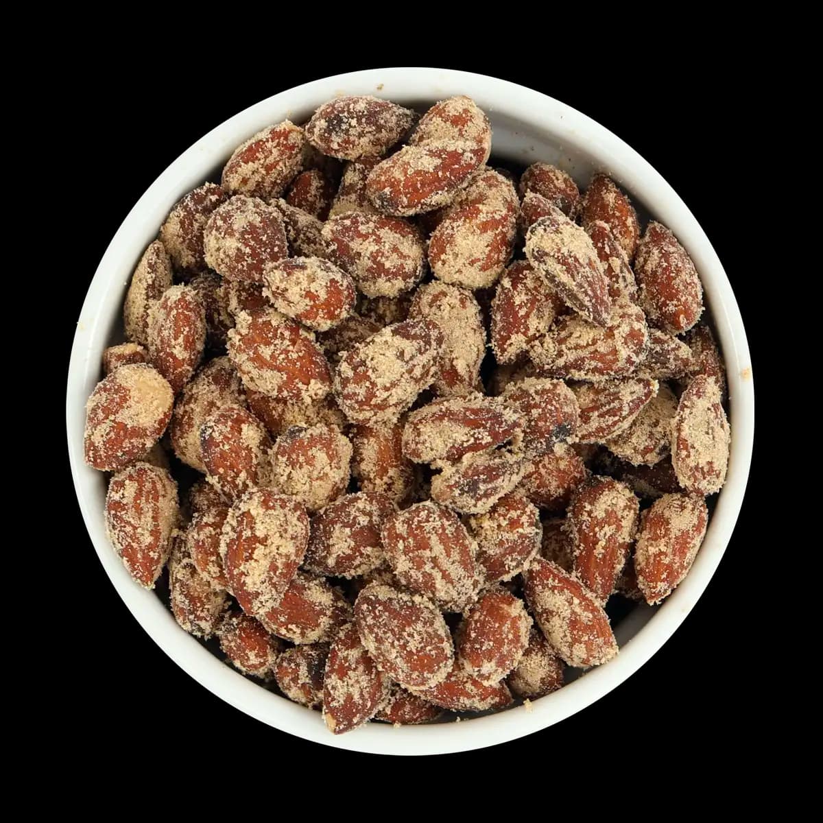 A white bowl filled with sugar-coated almonds is photographed against a solid black background.