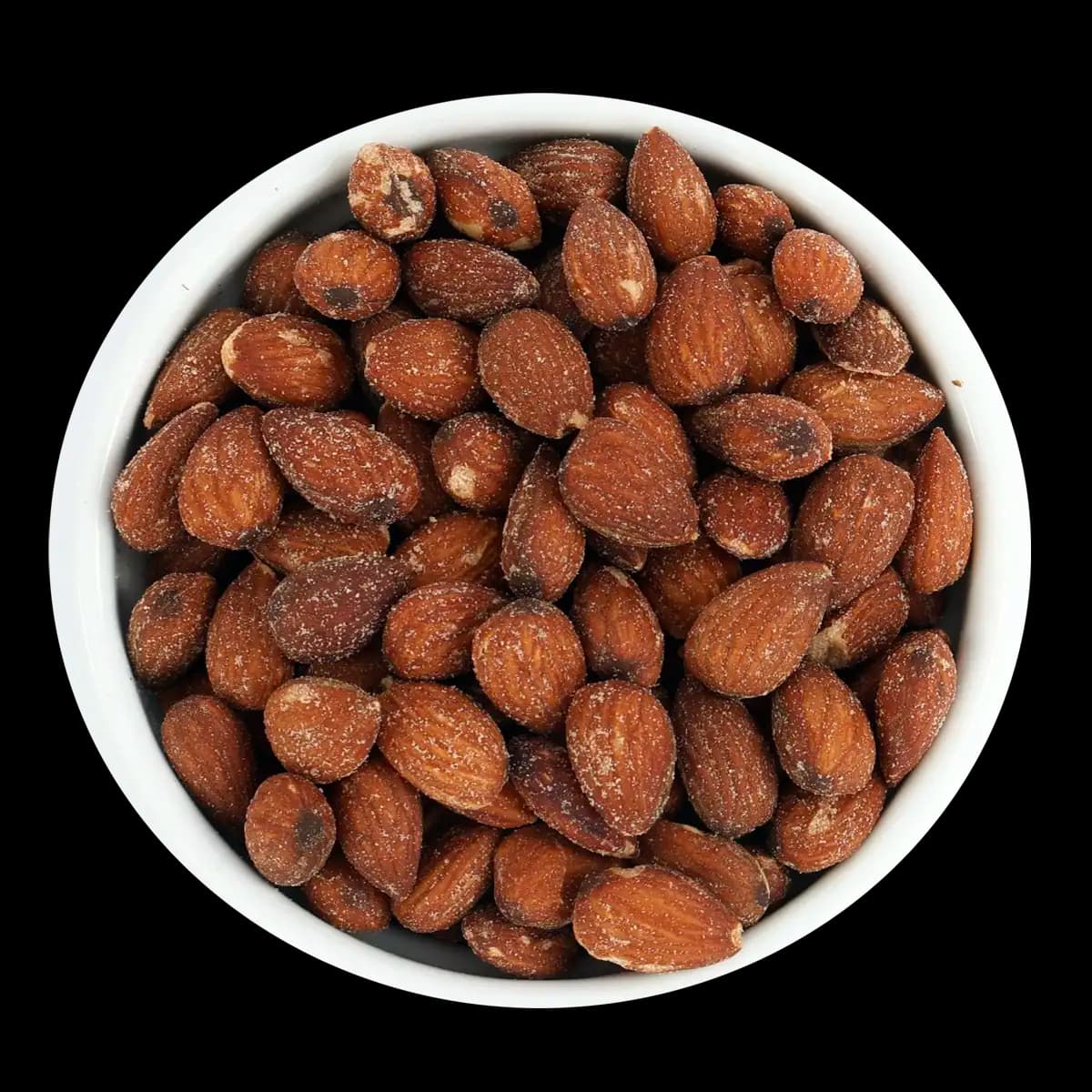 A white bowl filled with roasted almonds is shown against a black background.