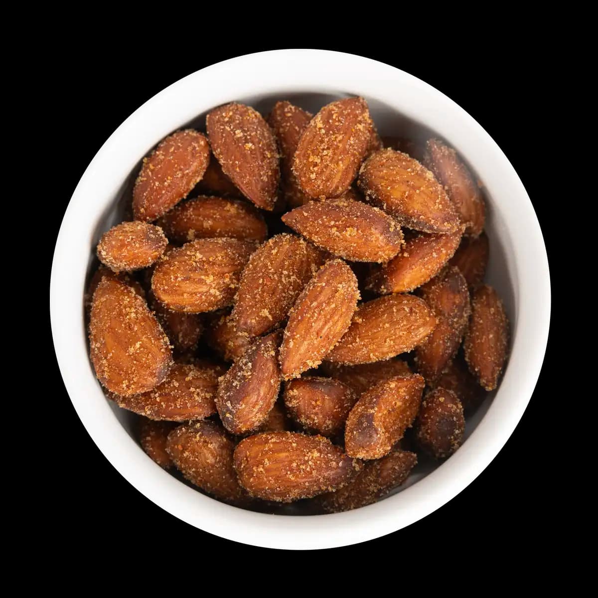 A white bowl filled with roasted almonds coated in seasoning, viewed from above on a black background.