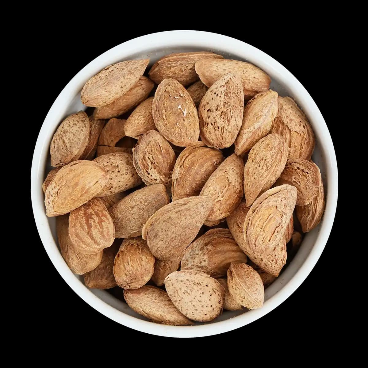 A white bowl filled with unshelled almonds, shown from above against a solid black background.
