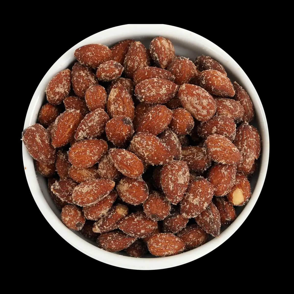 A white bowl filled with roasted almonds coated in seasoning, viewed from above on a black background.